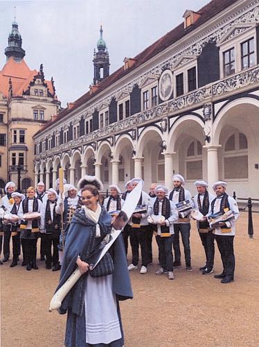 Junge Frau in historischer Kleidung mit einem großen Dresdner Stollenmesser